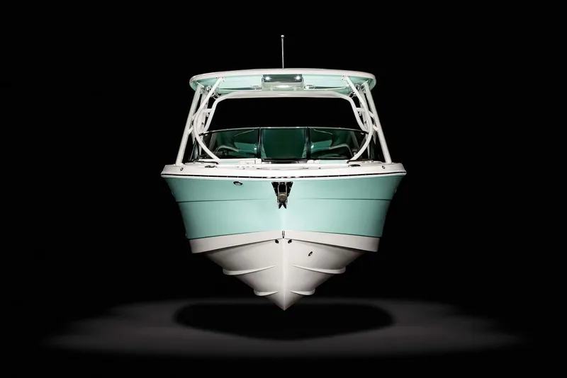 Slide: The Image of Manufacturer Provided Image: 2025 Robalo R317 Dual Console boat, front view, on black background. - 22