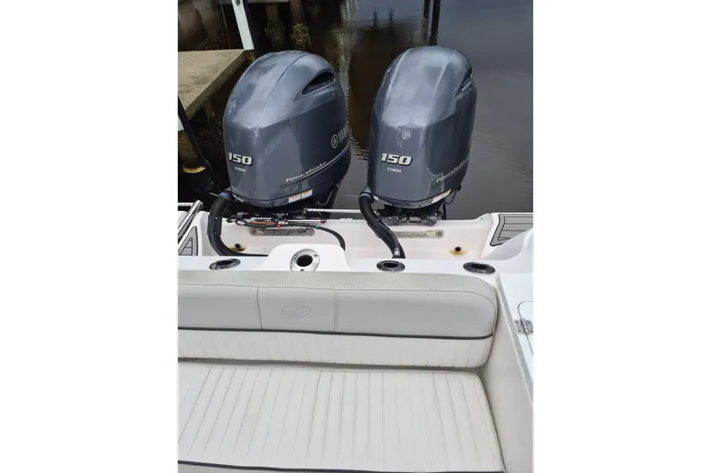 Slide: The Image of 2023 Sea Fox 268 Commander with twin Yamaha 150 engines, docked by the water. - 24
