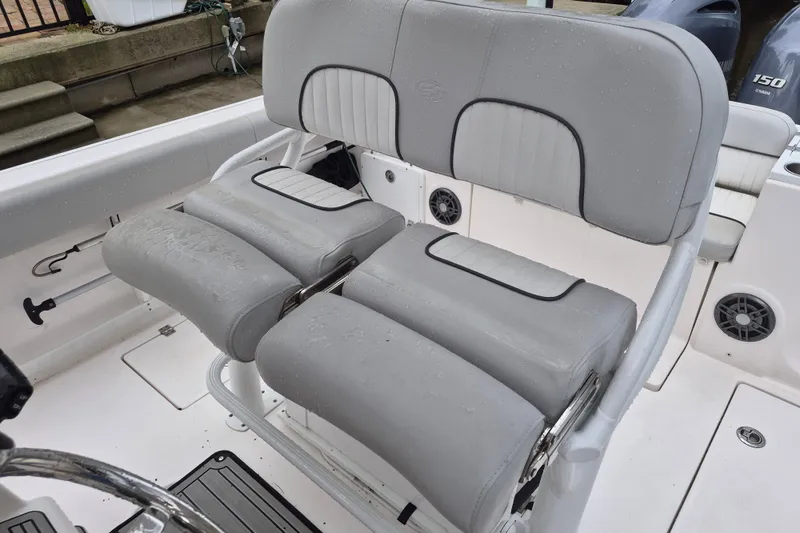 Slide: The Image of 2023 Sea Fox 268 Commander boat seating with gray upholstery and wet surfaces. - 17