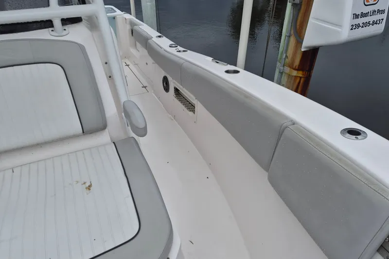 Slide: The Image of 2023 Sea Fox 268 Commander boat interior with cushioned seating and rod holders. - 12