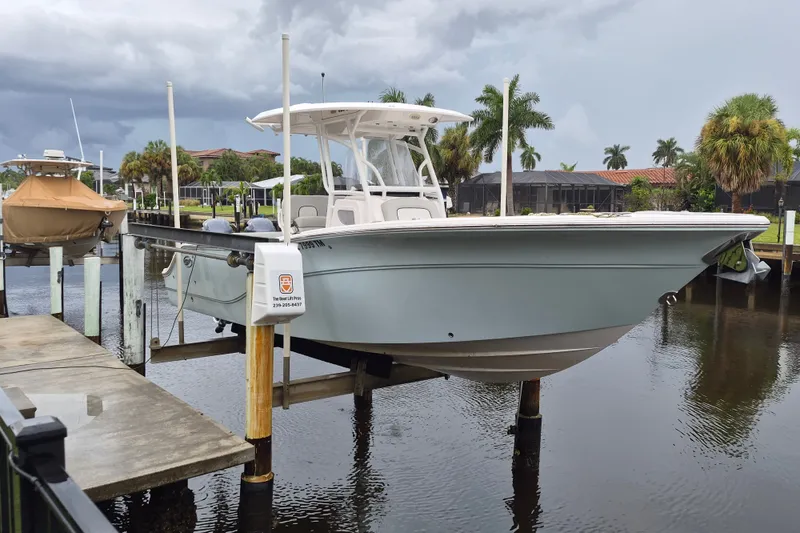 Slide: The Image of 2023 Sea Fox 268 Commander boat docked on a lift by a canal. - 3