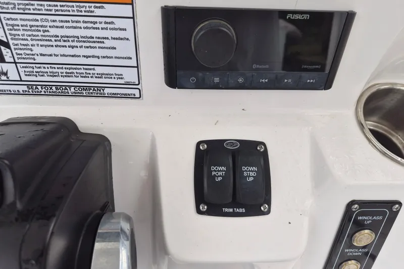Slide: The Image of 2023 Sea Fox 268 Commander dashboard with controls and warning labels. - 14
