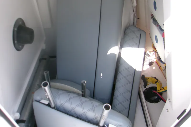 Slide: The Image of Interior storage of 2026 Sportsman Open 262 Center Console boat with cushions and equipment. - 16