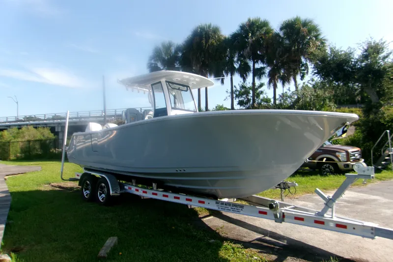 Slide: The Image of 2026 Sportsman Open 262 Center Console boat on trailer, parked outdoors. - 2