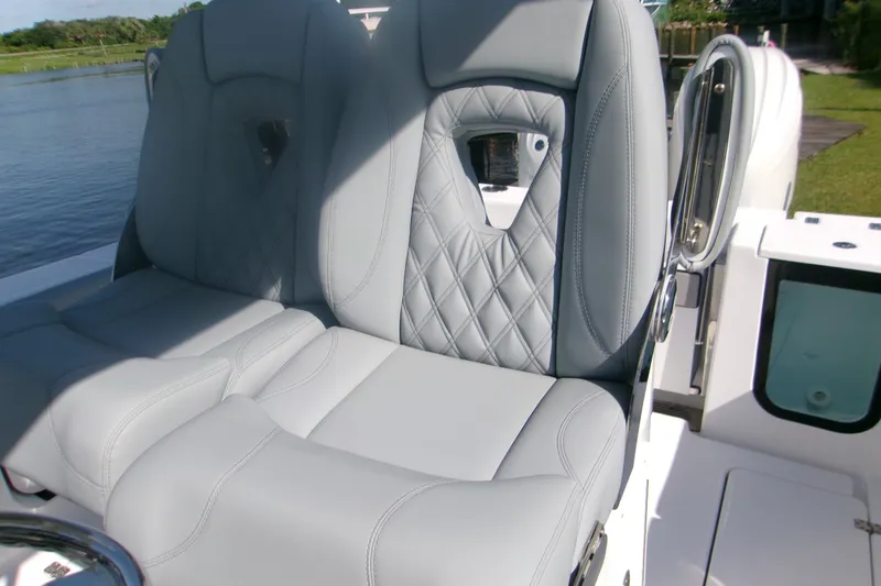 Slide: The Image of 2026 Sportsman Open 262 Center Console boat with luxurious gray seating. - 11