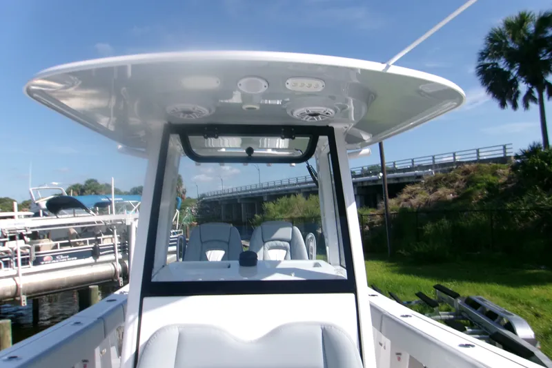 Slide: The Image of 2026 Sportsman Open 262 Center Console boat docked near a bridge on a sunny day. - 14