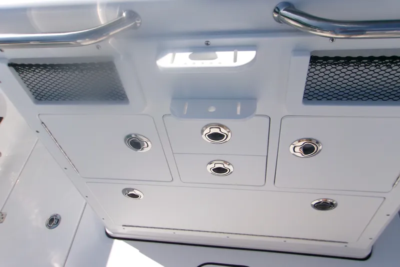 Slide: The Image of 2026 Sportsman Open 262 Center Console storage compartments with stainless steel handles and mesh pockets. - 7