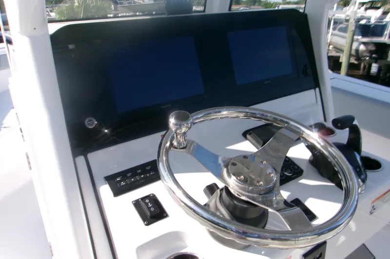 Slide: The Image of Steering console of 2026 Sportsman Open 262 Center Console boat with dual screens. - 10