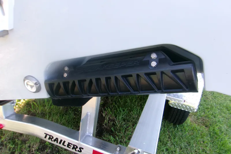 Slide: The Image of 2026 Sportsman Open 262 Center Console boat on trailer, featuring black keel protector. - 4