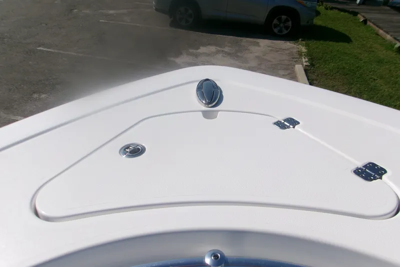 Slide: The Image of Bow of 2026 Sportsman Open 262 Center Console boat in a parking lot. - 15