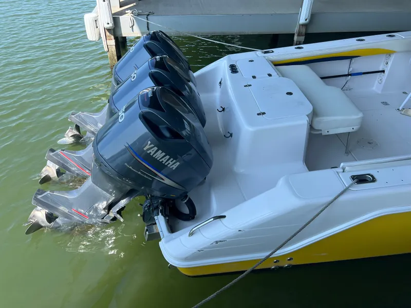 Slide: The Image of The image shows a 2001 Donzi 352F boat with three Yamaha outboard engines at the stern, docked. - 7