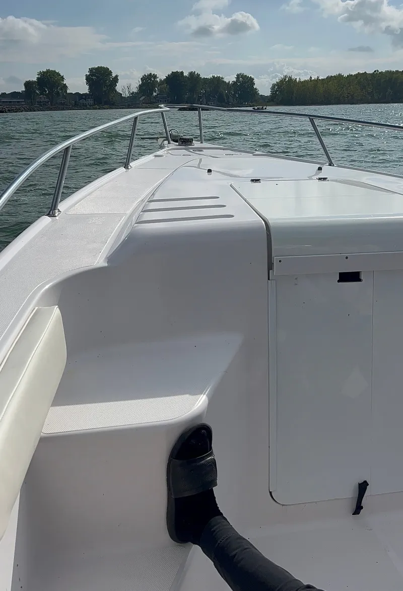 Slide: The Image of The image shows the deck of a 2001 Donzi 352F boat on the water. - 14