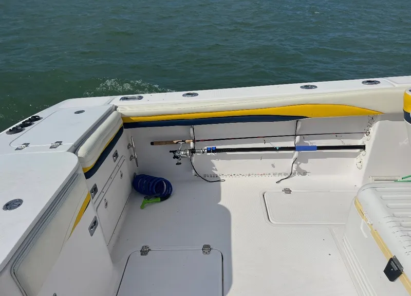 Slide: The Image of The image shows the stern of a 2001 Donzi 352F boat with fishing rod holders. - 9