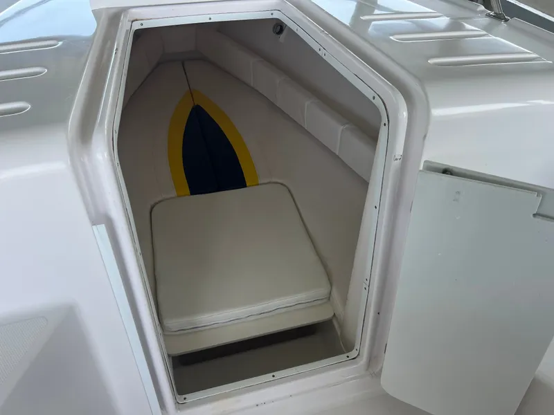 Slide: The Image of The cabin of a 2001 Donzi 352F with cushioned seating and storage space. - 18