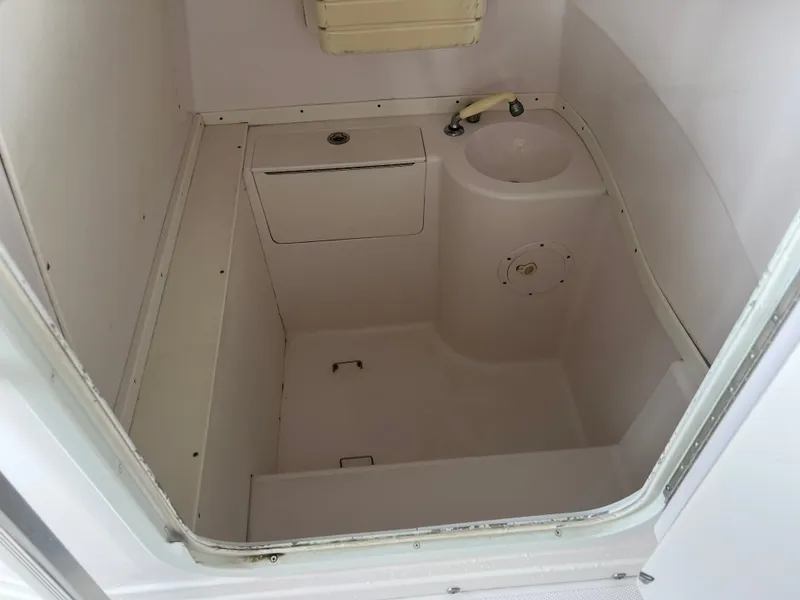 Slide: The Image of Interior of a 2001 Donzi 352F featuring a sink and storage area. - 16