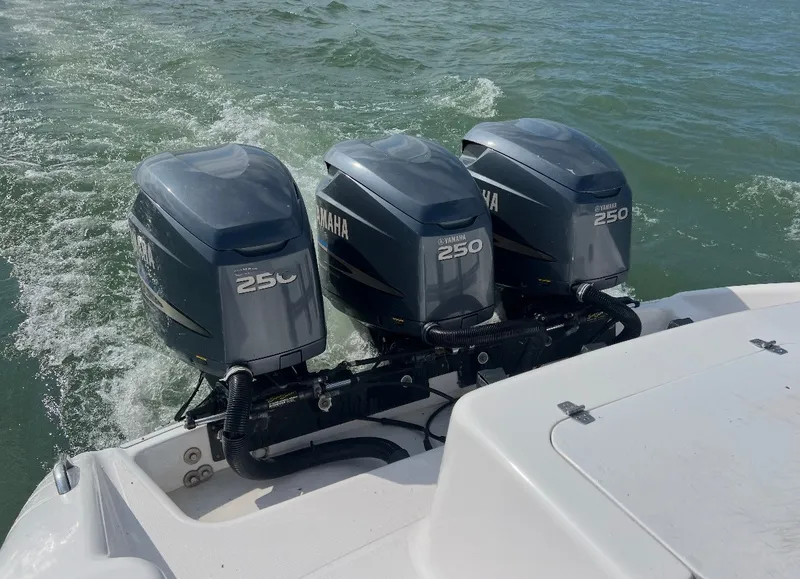 Slide: The Image of Three Yamaha 250 outboard engines on a 2001 Donzi 352F boat on the water. - 8