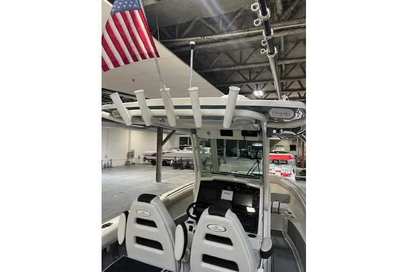Slide: The Image of 2021 Sailfish 272 CC boat interior with American flag and fishing rod holders. - 22