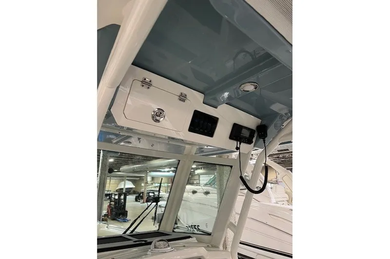 Slide: The Image of 2021 Sailfish 272 CC boat interior with control panel and storage compartment. - 16
