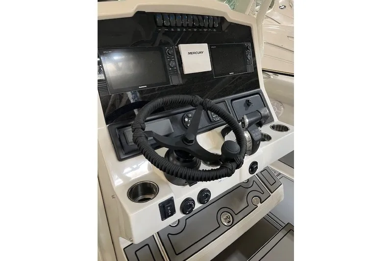 Slide: The Image of 2021 Sailfish 272 CC boat dashboard with steering wheel and navigation controls. - 17
