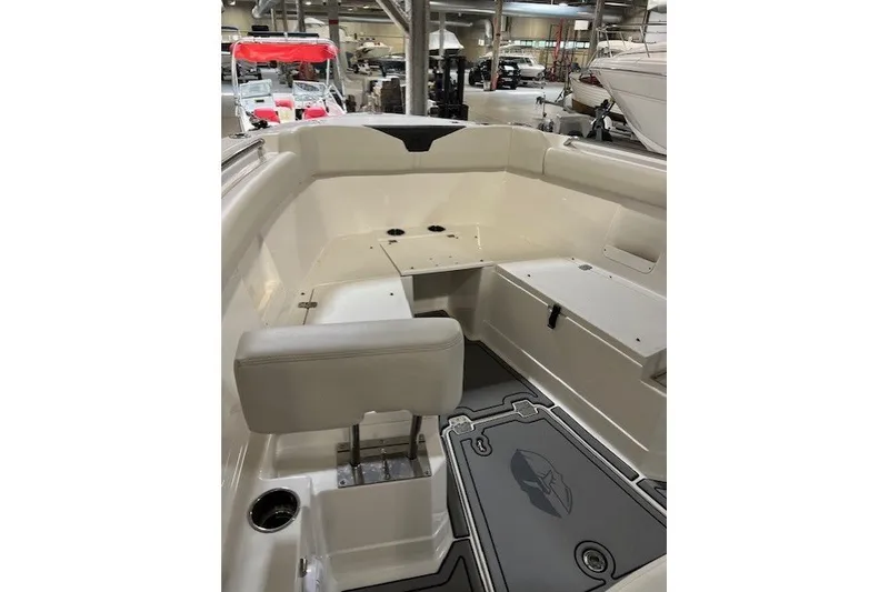 Slide: The Image of 2021 Sailfish 272 CC boat interior with seating and storage in a showroom. - 21