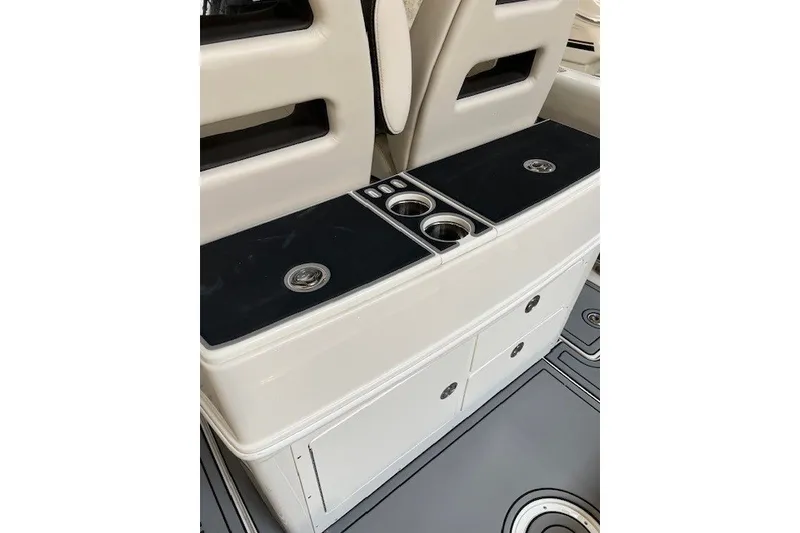 Slide: The Image of Interior of 2021 Sailfish 272 CC boat featuring storage compartments and cup holders. - 24