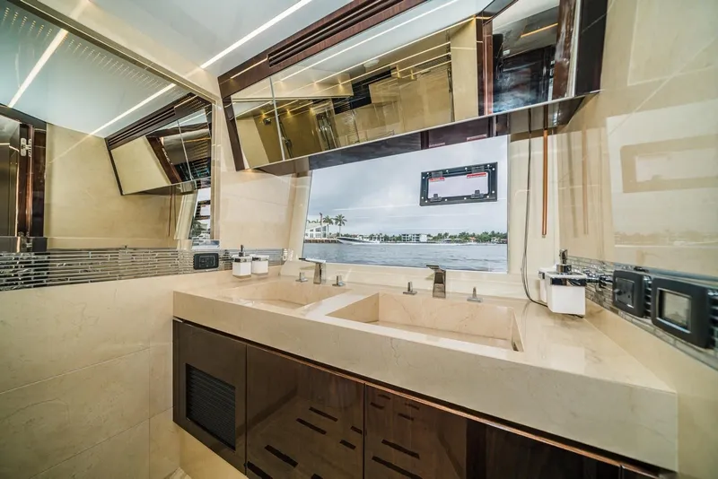 Slide: The Image of Luxurious bathroom interior of 2020 Galeon 680 Fly yacht with dual sinks and scenic window view. - 23