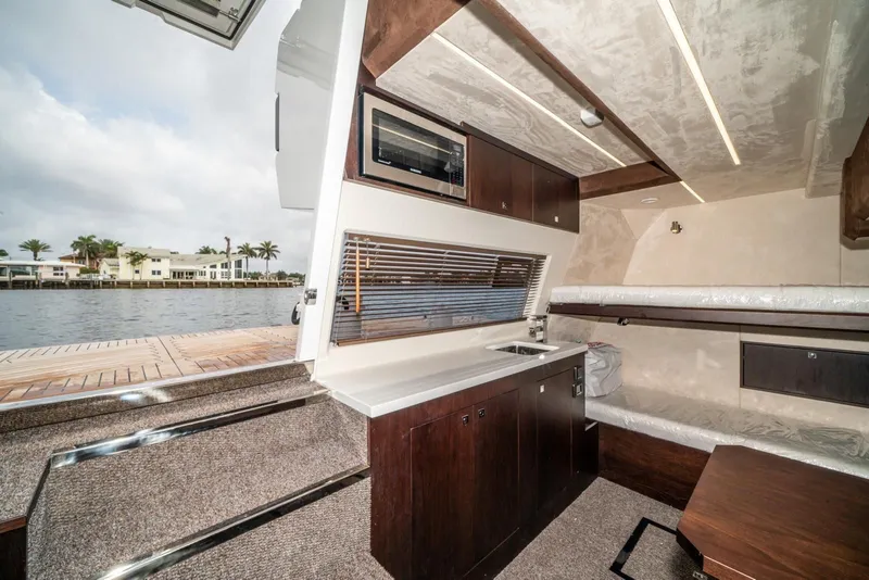 Slide: The Image of Interior of 2020 Galeon 680 Fly yacht with modern kitchen and seating area. - 31