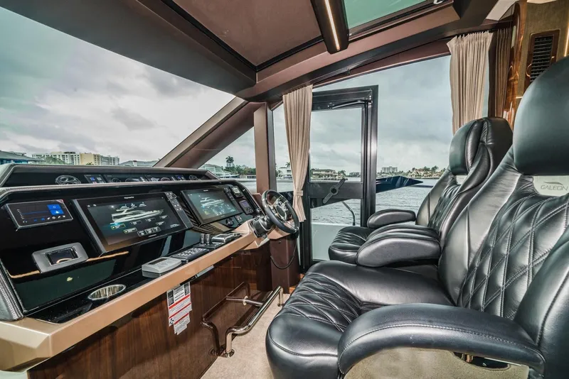Slide: The Image of Luxurious interior of 2020 Galeon 680 Fly yacht with leather seating and advanced navigation displays. - 16