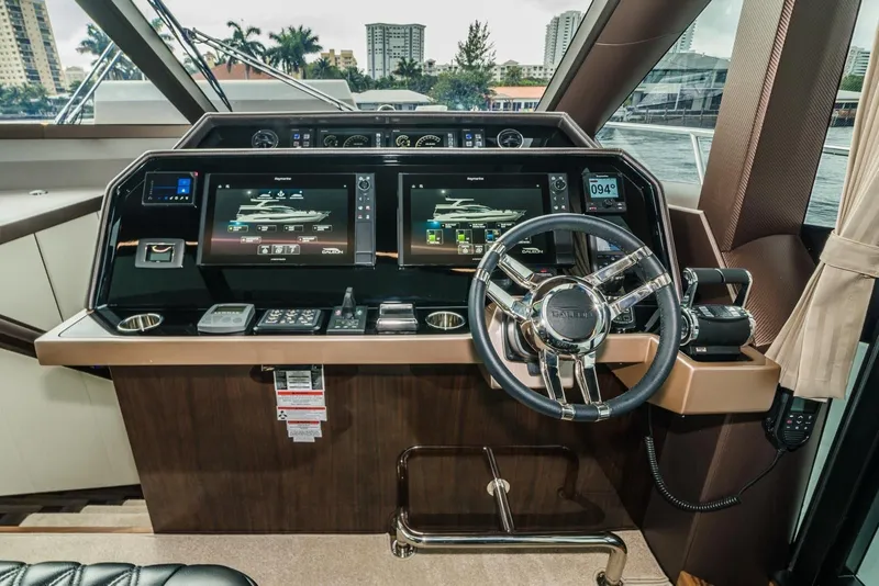 Slide: The Image of Cockpit of 2020 Galeon 680 Fly yacht with advanced navigation displays and controls. - 17