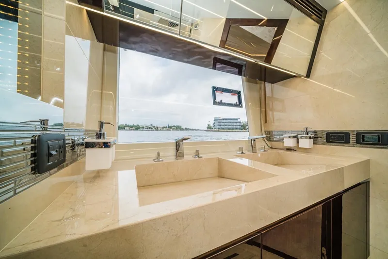 Slide: The Image of Luxurious bathroom interior on 2020 Galeon 680 Fly yacht with dual sinks and scenic window view. - 26