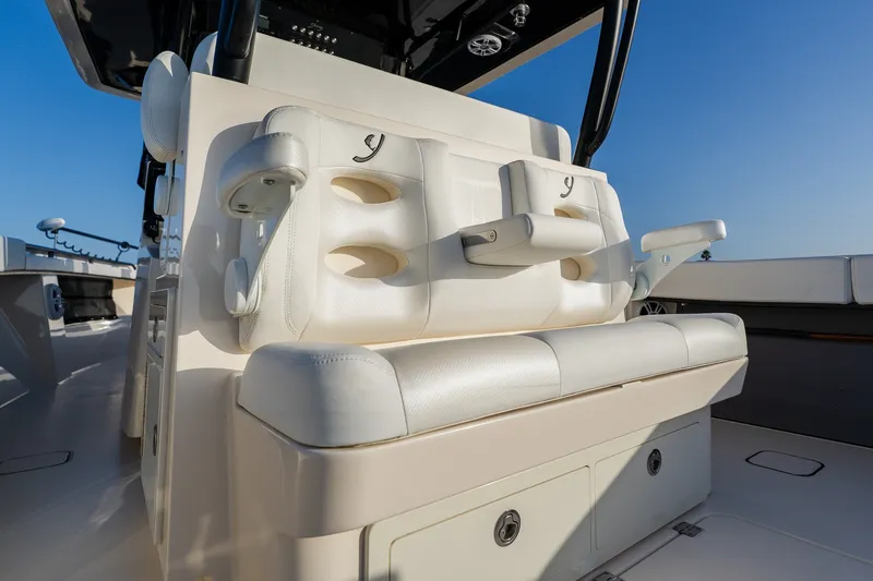 Slide: The Image of Luxury seating on 2023 Young 34 boat, featuring white leather and armrests. - 39