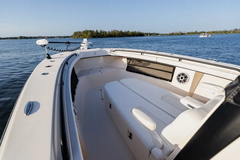 Slide: The Image of Luxury Young 34 boat interior with plush seating, cruising on a serene lake, 2023 model. - 13