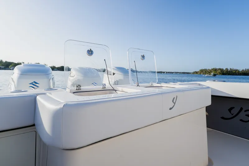 Slide: The Image of Luxury Young 34 boat with dual engines on a serene water backdrop, 2023 model. - 47