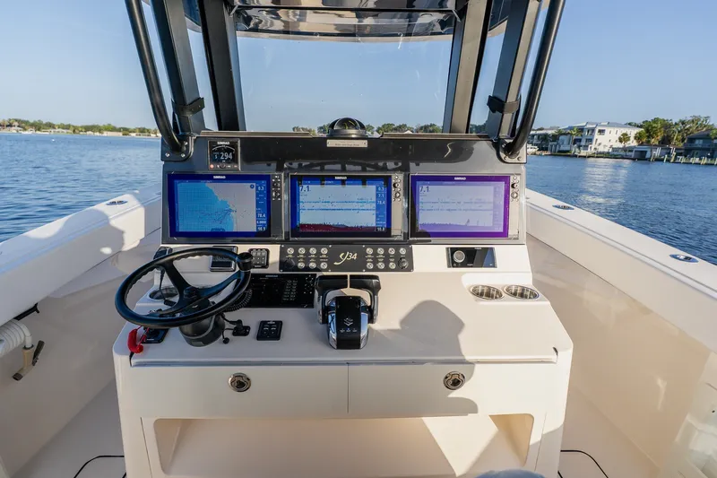 Slide: The Image of Cockpit of 2023 Young 34 boat with advanced navigation displays and steering wheel. - 30
