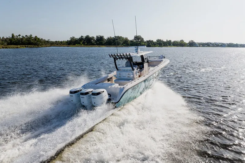 Slide: The Image of Powerful 2023 Young 34 boat cruising swiftly on a scenic lake. - 11