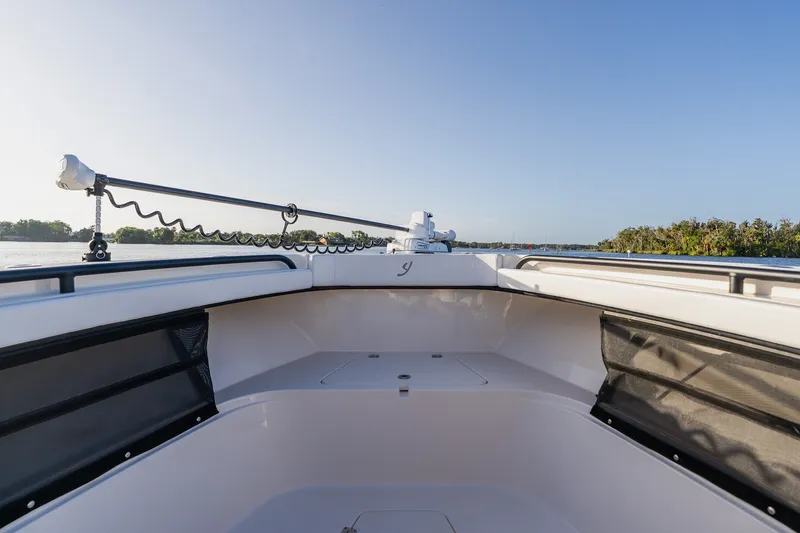 Slide: The Image of Bow view of 2023 Young 34 boat on calm water, clear sky background. - 17