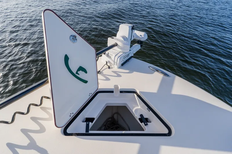 Slide: The Image of Open hatch on Young 34 boat deck, 2023 model, with water in the background. - 15