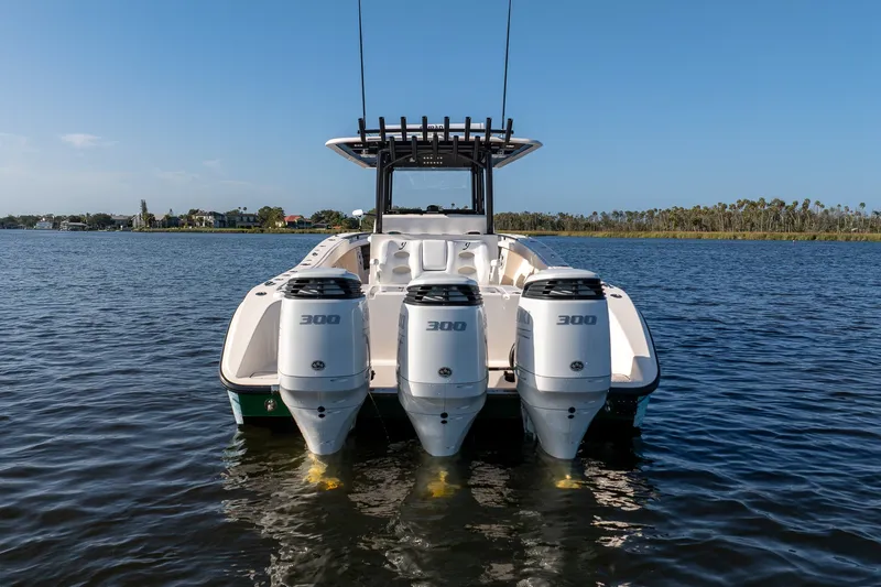 Slide: The Image of Powerful Young 34 boat with triple 300 horsepower engines on calm water, 2023 model. - 3