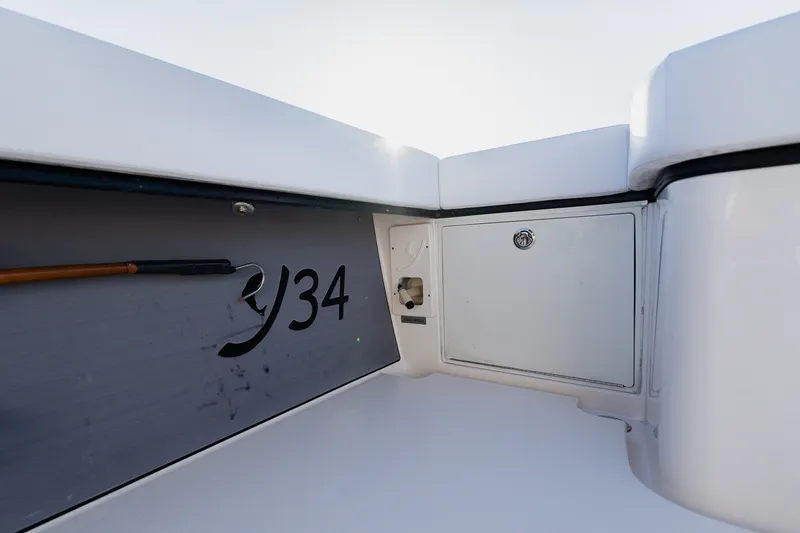 Slide: The Image of Interior view of a 2023 Young 34 boat, featuring storage compartment and sleek design. - 52