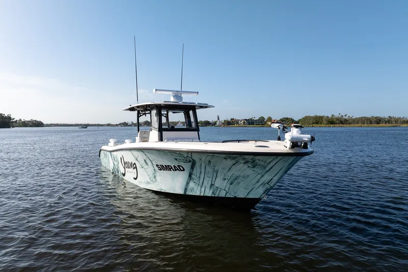 Slide: The Image of Young 34 boat on calm water, 2023 model, clear sky background. - 4