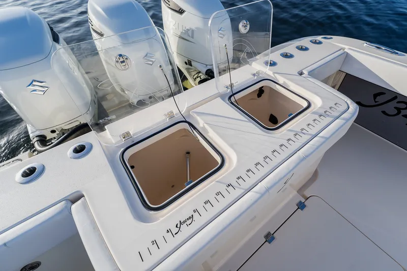 Slide: The Image of Fishing boat deck with dual livewells, Suzuki engines, and measurement markings, Young 34 model 2023. - 46