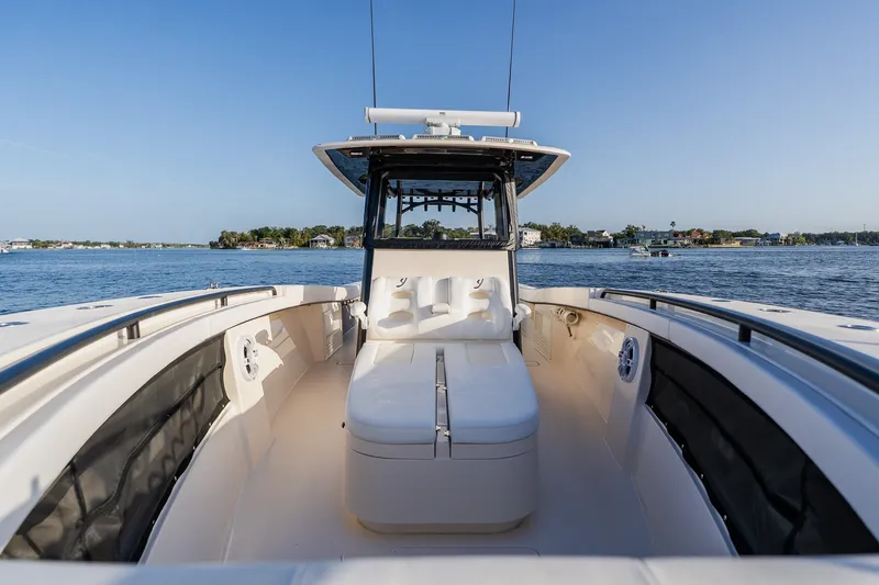 Slide: The Image of Modern 2023 Young 34 boat interior with seating, on calm water, clear blue sky. - 21