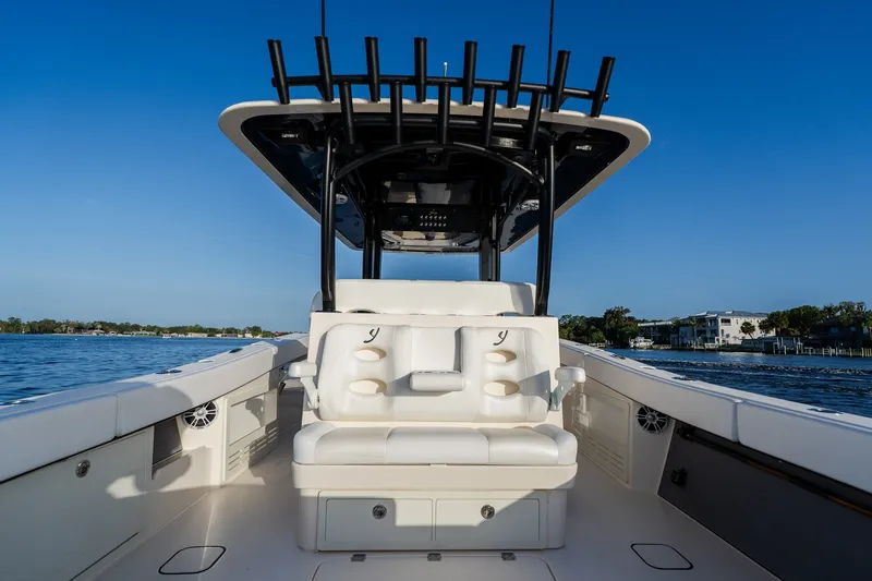 Slide: The Image of Luxury Young 34 boat interior with cushioned seating, sleek design, and waterfront view, 2023 model. - 35