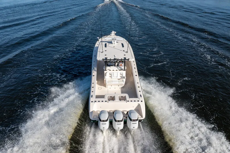 Slide: The Image of A 2023 Young 34 boat cruising on open water with powerful engines. - 12