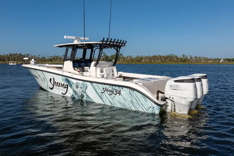 Slide: The Image of Young 34 boat, 2023 model, with Suzuki engines on calm water. - 2