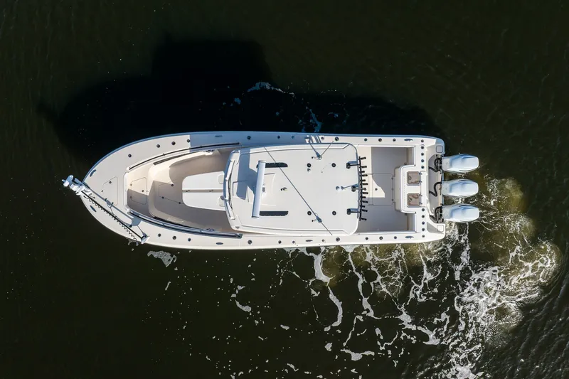 Slide: The Image of Aerial view of 2023 Young 34 boat with triple engines on water. - 6