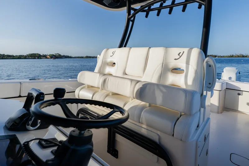 Slide: The Image of Luxury seating on 2023 Young 34 boat, overlooking serene water and clear sky. - 27