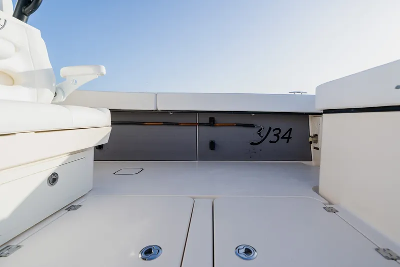 Slide: The Image of Interior view of a 2023 Young 34 boat, showcasing seating and storage compartments. - 50