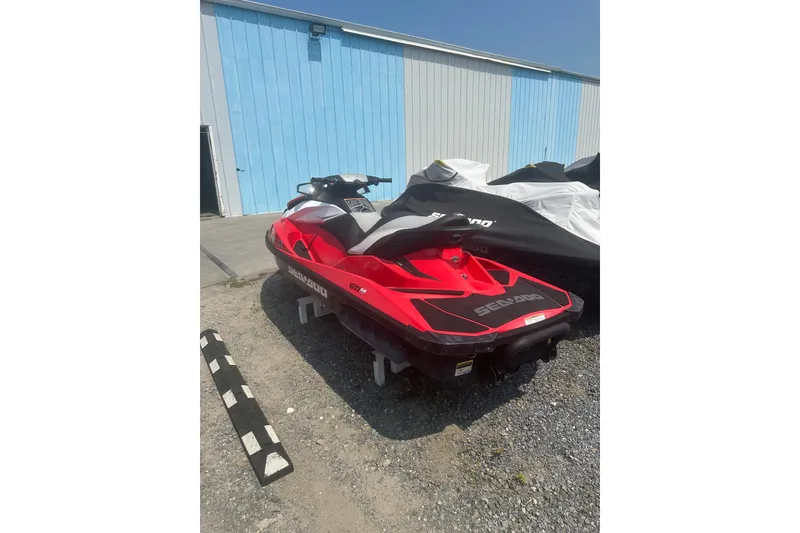 Slide: The Image of Red 2012 Sea-Doo GTI SE jet ski parked outdoors near a blue building. - 9