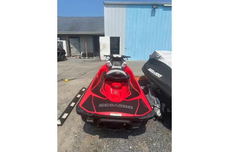 Slide: The Image of Red 2012 Sea-Doo GTI SE jet ski parked outdoors near a blue building. - 8